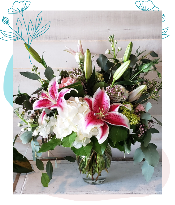 white hydrangea and stargazer lily flower arrangement in glass vase