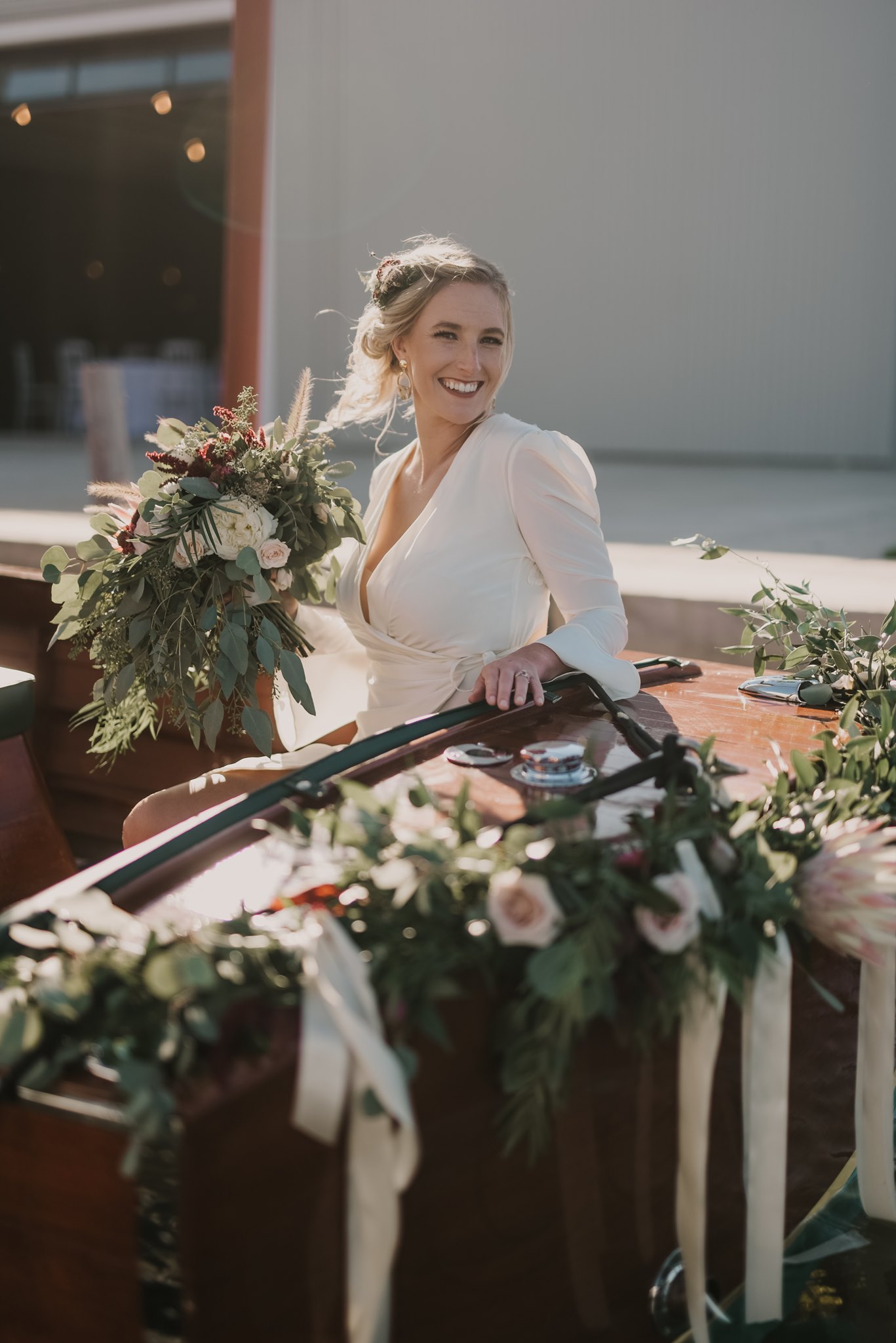 bride holding greenery bouquet