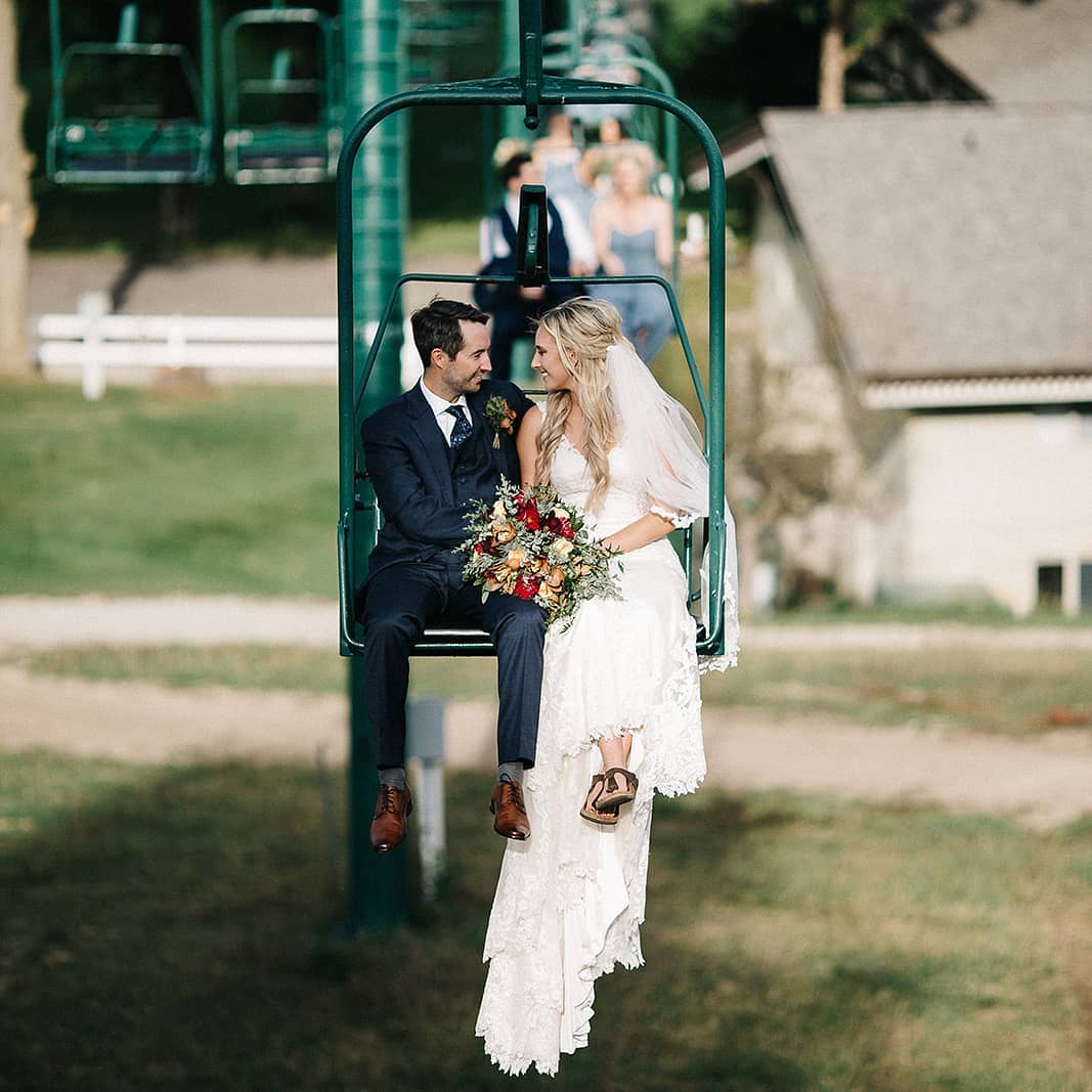 bride and groom on ski lift
