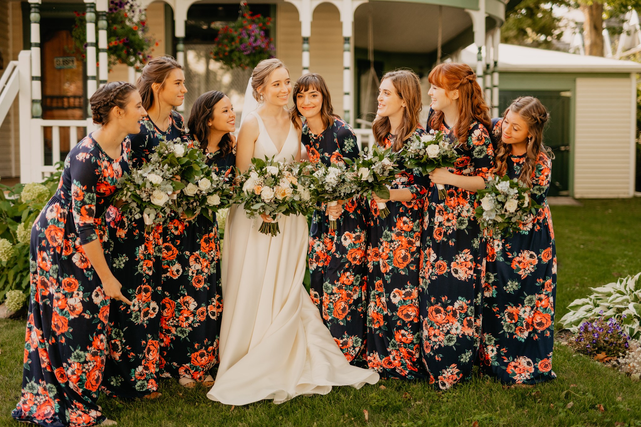 bride with bridesmaids in navy floral print dresses