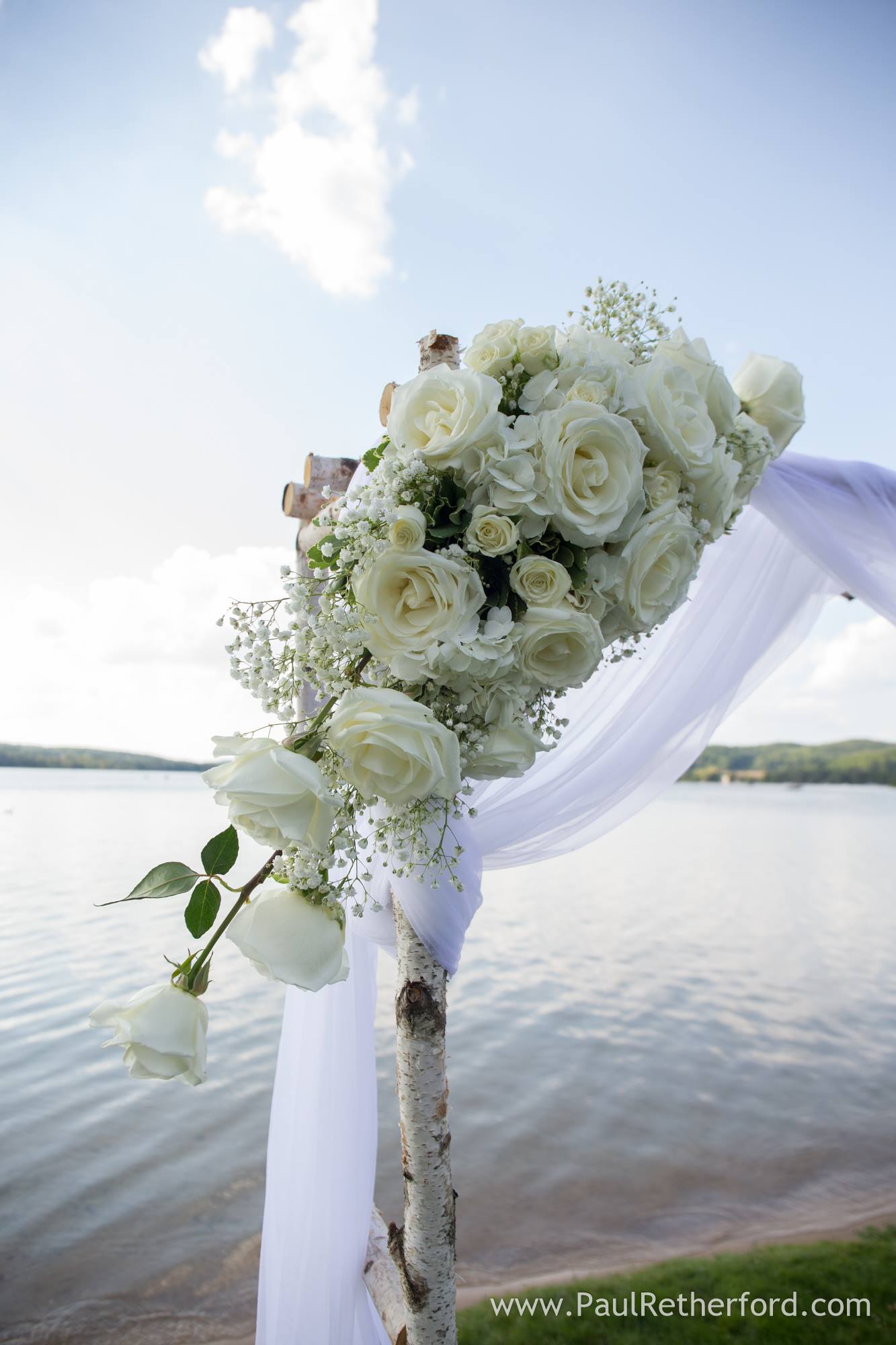 white wedding ceremony flowers on arch
