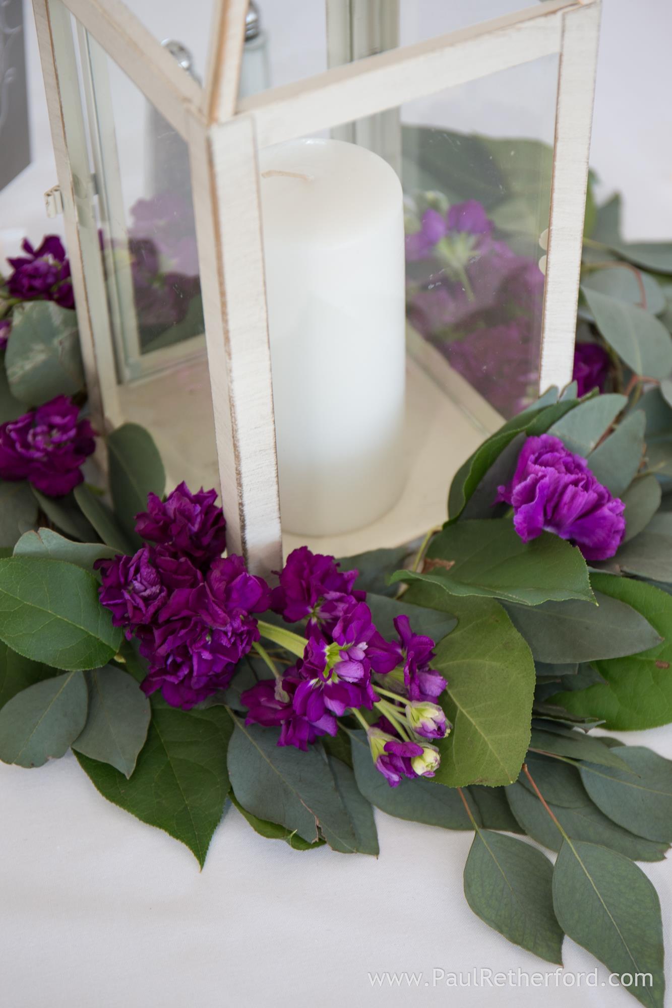 purple floral centerpiece with candle