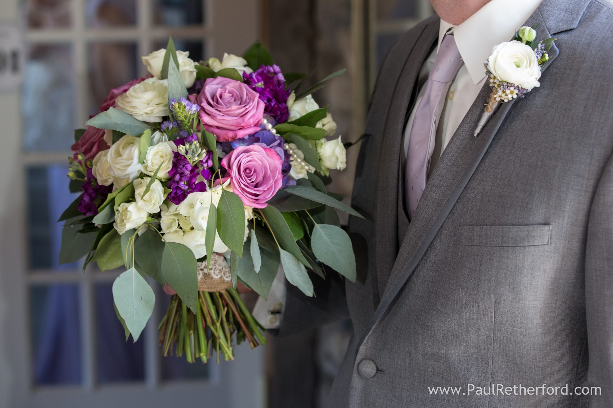 white and purple bouquet and boutonniere for wedding