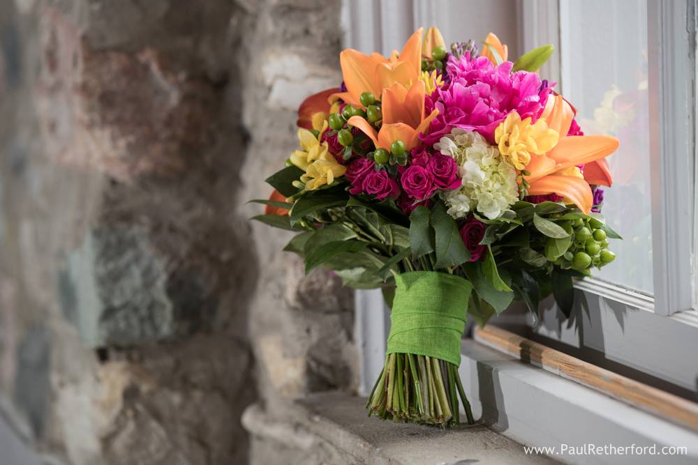 pink, yellow, and orange bridal bouquet with lilies and hydrangea