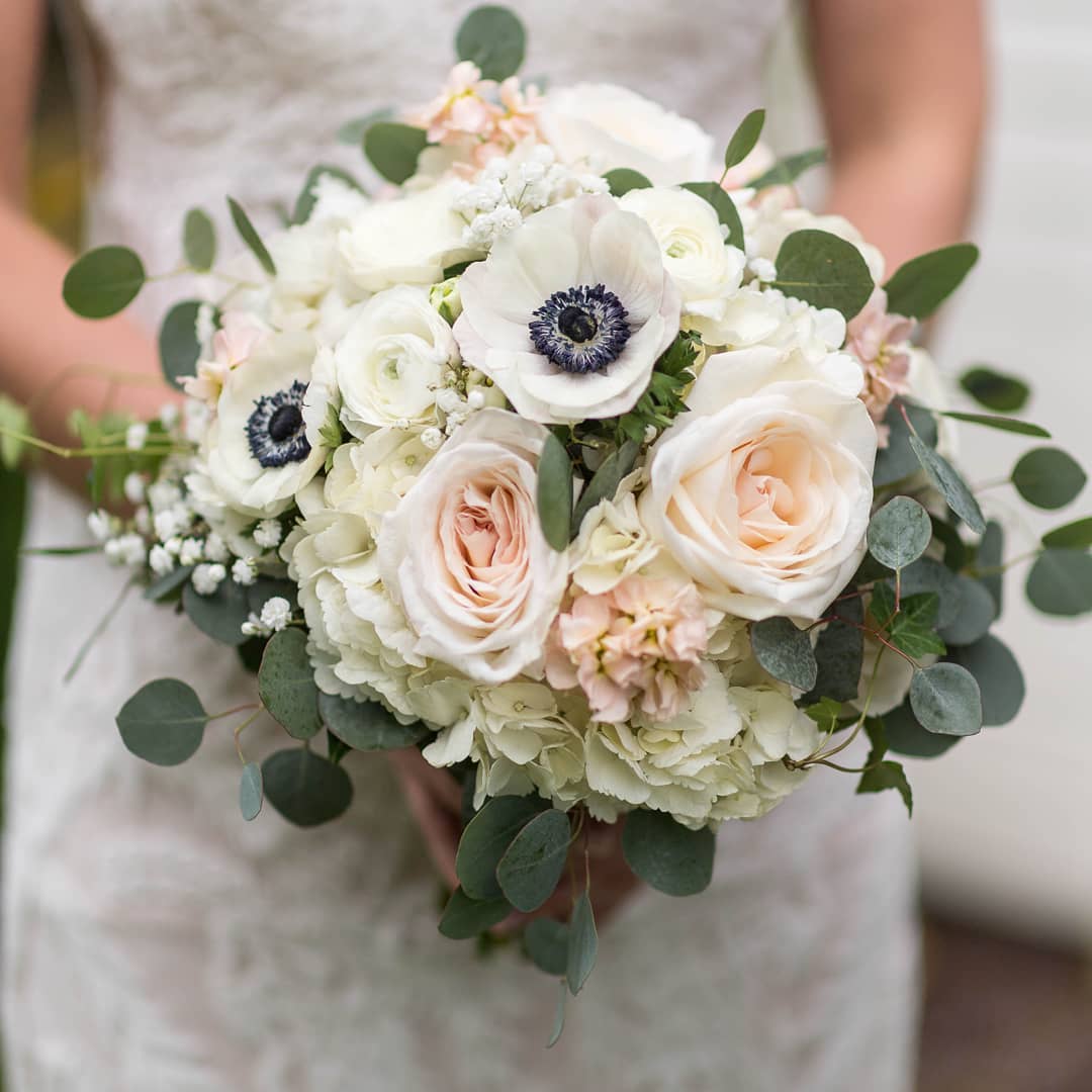 bridal bouquet with white roses, hydrangeas, and anemones