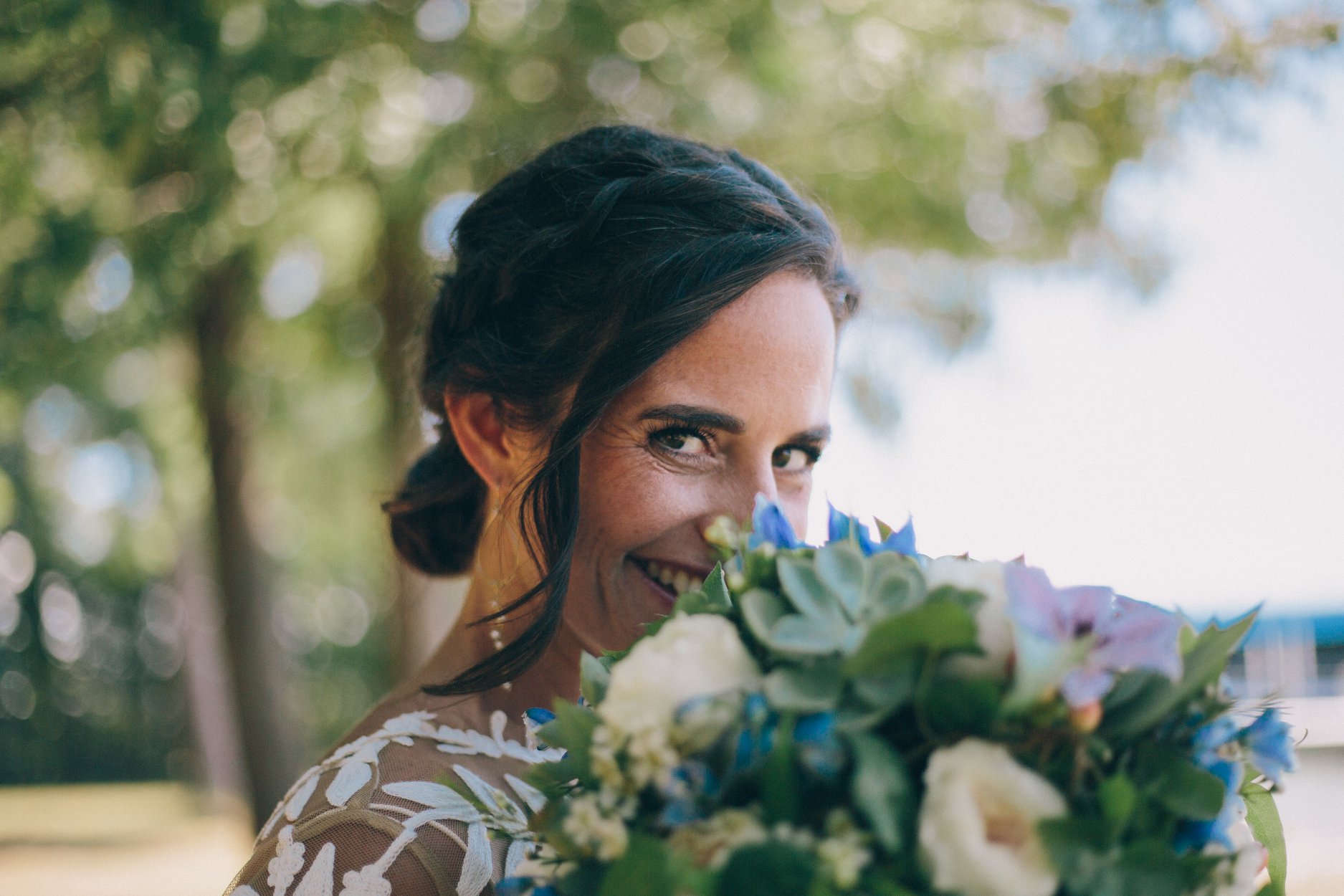 bride looking over succulent bridal bouquet